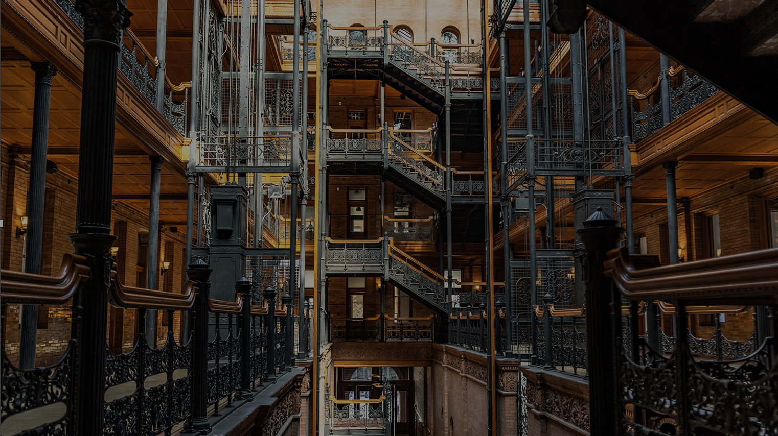 Intricate iron staircases inside an old industrial building.